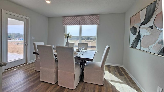8614 Brooklyn Ct, Semmes, AL 36575 - dining space featuring dark wood-type flooring, a healthy amount of sunlight, and baseboards