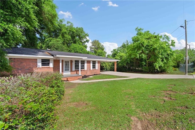 754 Pinemont Dr, Mobile, AL 36609 - single story home with driveway, brick siding, a front yard, and a carport