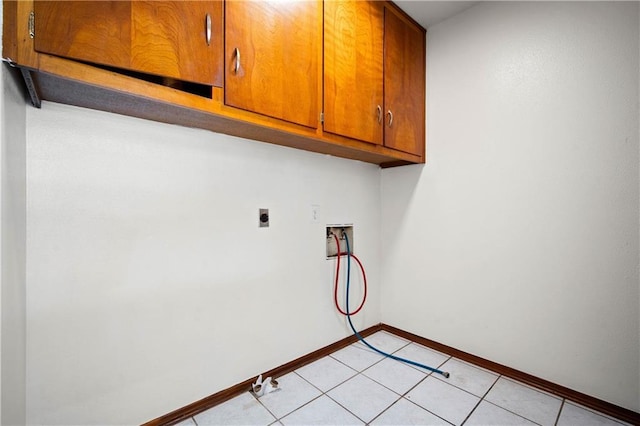 754 Pinemont Dr, Mobile, AL 36609 - laundry room featuring cabinet space, hookup for a washing machine, hookup for an electric dryer, baseboards, and light tile patterned floors