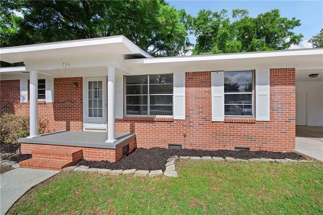 754 Pinemont Dr, Mobile, AL 36609 - view of front of house with brick siding, driveway, a carport, and crawl space