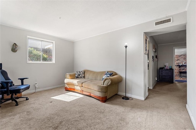 carpeted living room with visible vents, baseboards, a textured ceiling, and ornamental molding