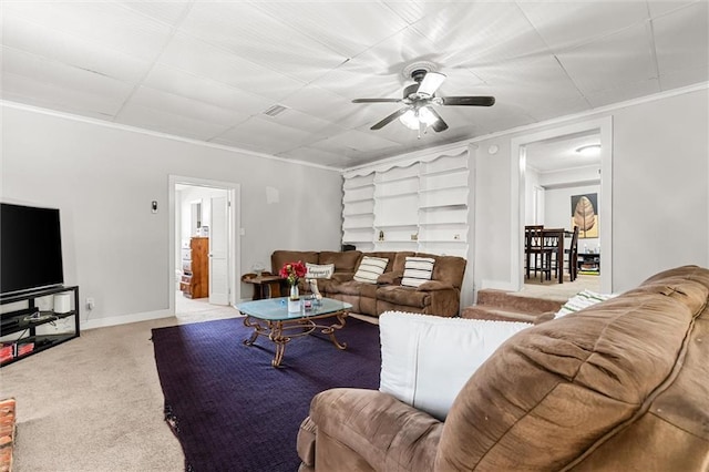 living room featuring visible vents, a ceiling fan, carpet, crown molding, and baseboards