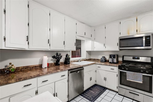 kitchen featuring a sink, white cabinets, and stainless steel appliances