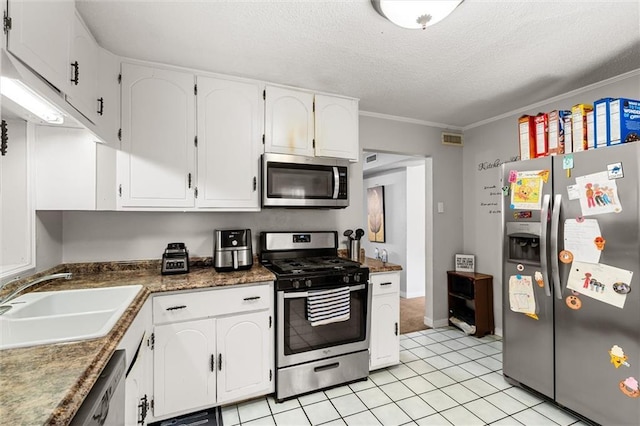 kitchen with visible vents, white cabinetry, stainless steel appliances, and a sink