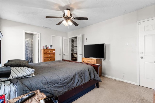 bedroom with visible vents, baseboards, carpet flooring, a textured ceiling, and a ceiling fan