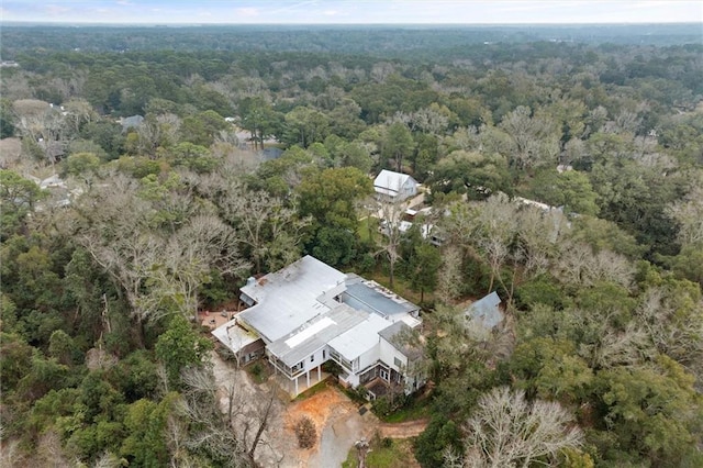 birds eye view of property featuring a forest view