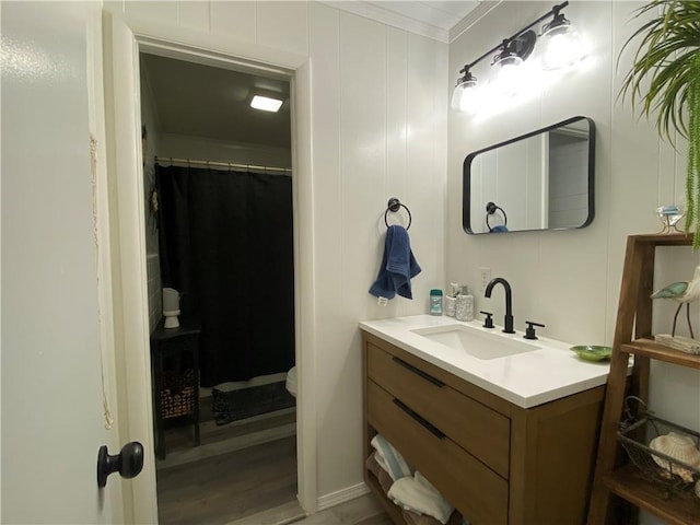 full bath featuring wood finished floors, vanity, toilet, ornamental molding, and a shower with shower curtain