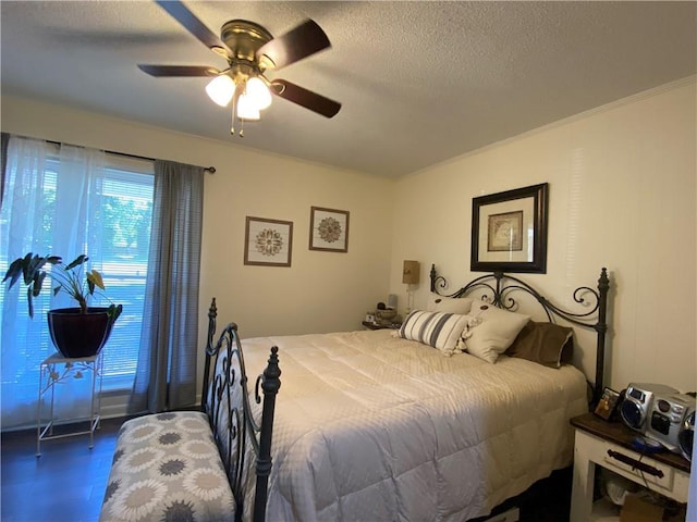 bedroom with ceiling fan and a textured ceiling