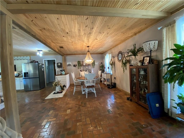 dining area featuring baseboards, wood ceiling, and brick floor