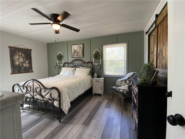 bedroom featuring a ceiling fan and wood finished floors