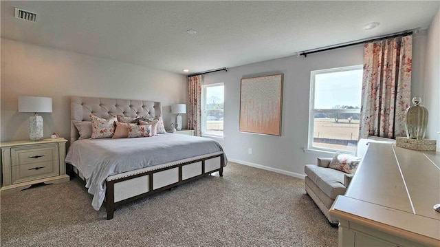 bedroom with baseboards, visible vents, and light colored carpet
