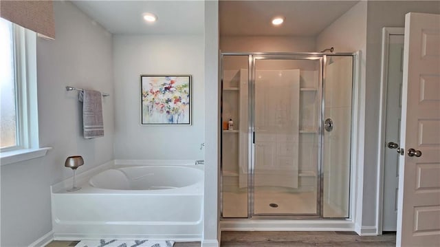 bathroom featuring recessed lighting, a garden tub, wood finished floors, and a stall shower