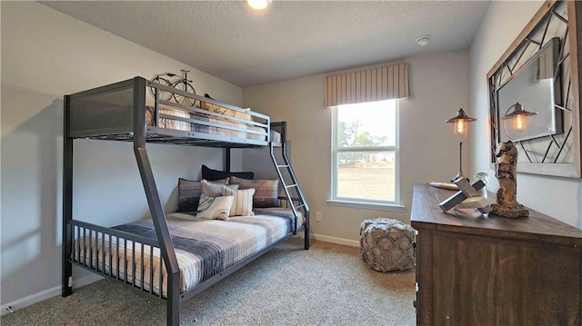 bedroom with carpet floors, a textured ceiling, and baseboards