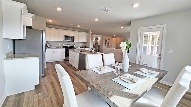 dining space with recessed lighting, baseboards, visible vents, and dark wood-style floors