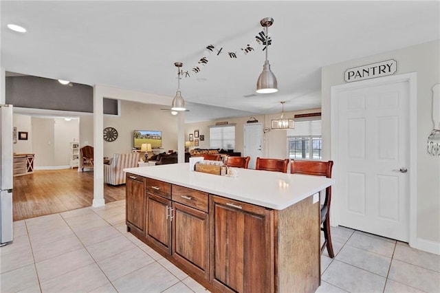 kitchen featuring light tile patterned flooring, pendant lighting, and light countertops