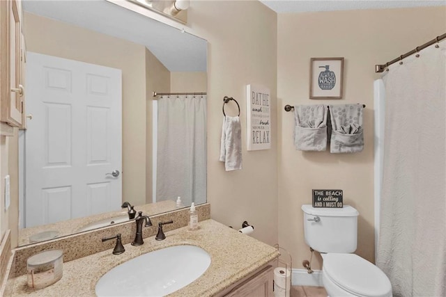 bathroom with vanity, a shower with shower curtain, and toilet