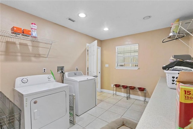 washroom with recessed lighting, light tile patterned flooring, baseboards, laundry area, and washing machine and clothes dryer