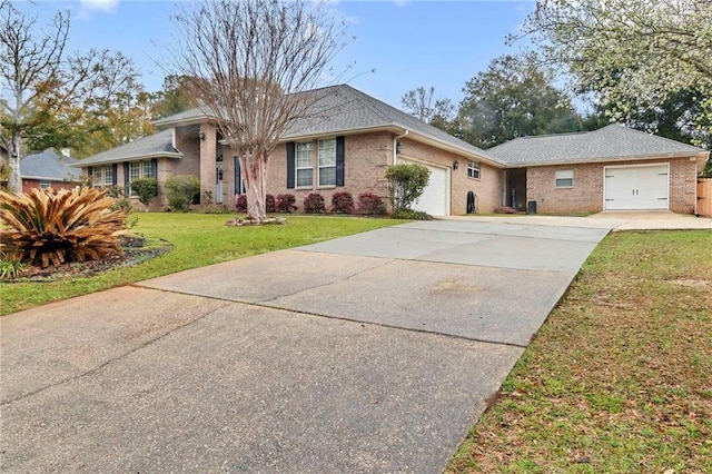 ranch-style house with brick siding, an attached garage, concrete driveway, and a front yard