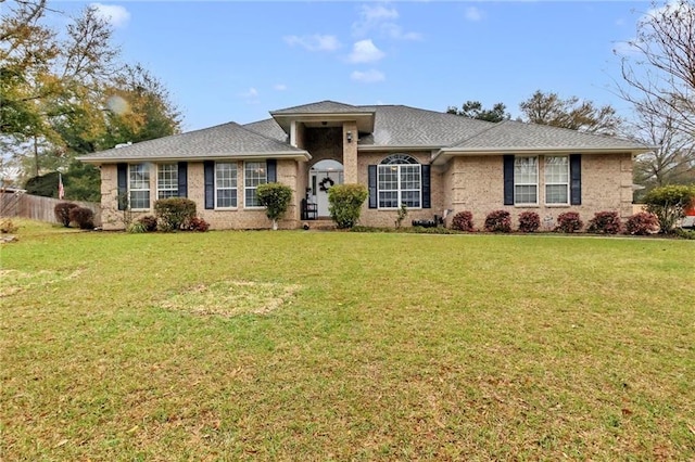 view of front facade with a front yard and fence