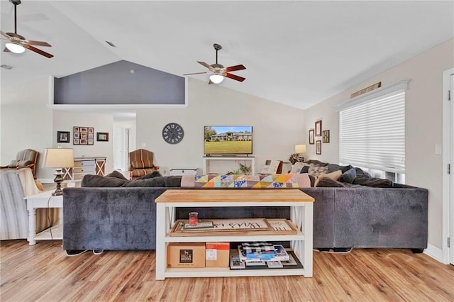 living room featuring ceiling fan, lofted ceiling, and wood finished floors