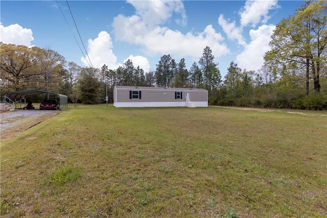 exterior space with a front lawn, driveway, and a detached carport
