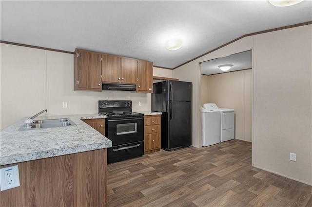 kitchen featuring a sink, extractor fan, black appliances, light countertops, and independent washer and dryer