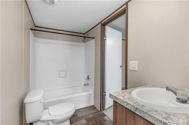 bathroom with wood finished floors, visible vents, toilet, vanity, and  shower combination