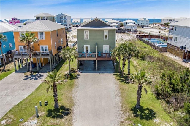 1449 Lagoon Dr W Unit B, Gulf Shores, AL 36542 - view of front facade featuring a carport, concrete driveway, and a residential view