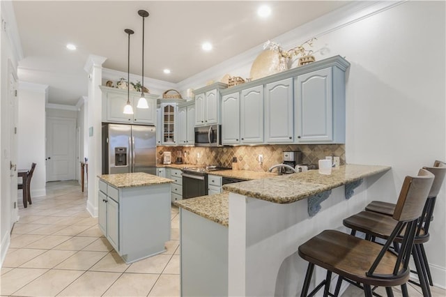 1449 Lagoon Dr W Unit B, Gulf Shores, AL 36542 - kitchen with appliances with stainless steel finishes, crown molding, a peninsula, decorative backsplash, and light tile patterned floors