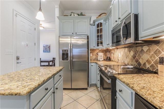 1449 Lagoon Dr W Unit B, Gulf Shores, AL 36542 - kitchen with appliances with stainless steel finishes, crown molding, decorative backsplash, light tile patterned flooring, and glass insert cabinets