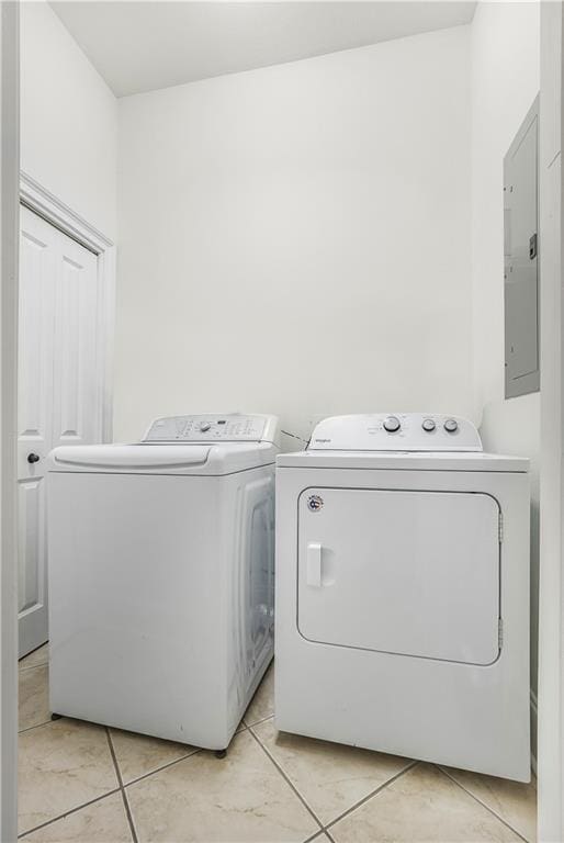 1449 Lagoon Dr W Unit B, Gulf Shores, AL 36542 - laundry area with washer and dryer, electric panel, and light tile patterned floors