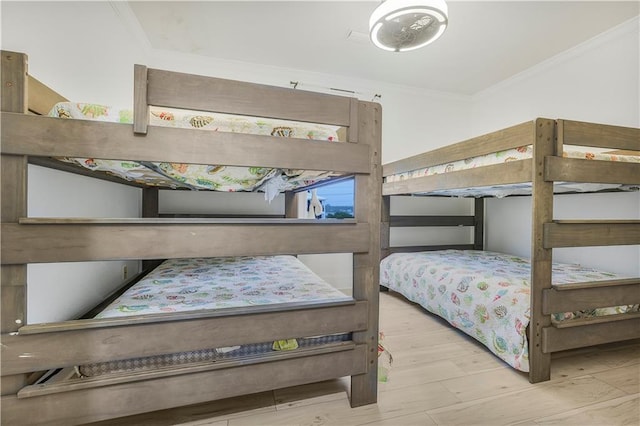 1449 Lagoon Dr W Unit B, Gulf Shores, AL 36542 - bedroom with crown molding and wood finished floors