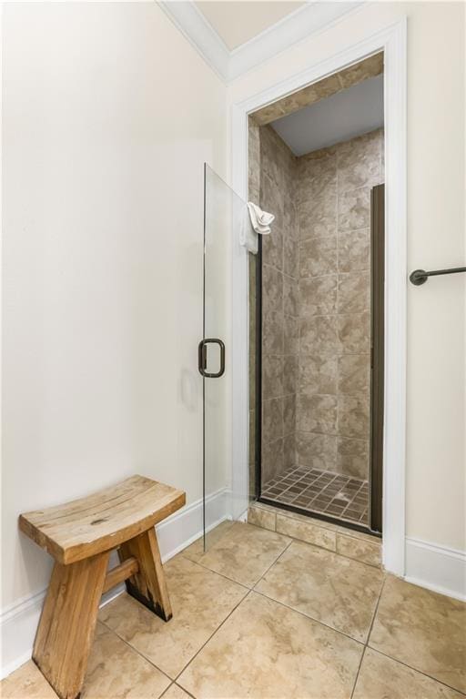 1449 Lagoon Dr W Unit B, Gulf Shores, AL 36542 - bathroom featuring a stall shower, crown molding, baseboards, and tile patterned floors