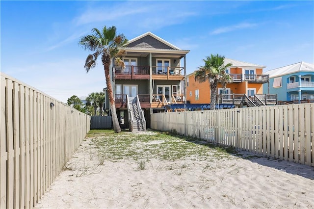 1449 Lagoon Dr W Unit B, Gulf Shores, AL 36542 - back of house with a fenced backyard, a balcony, stairs, and french doors