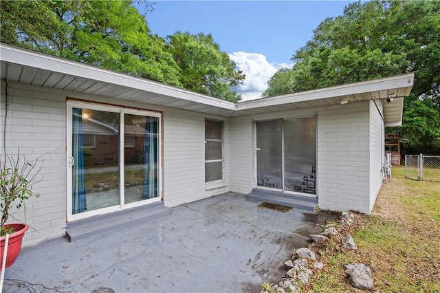4359 Montclair Cir E, Mobile, AL 36693 - rear view of house with a patio, fence, and brick siding
