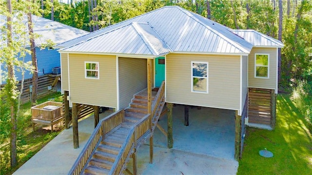 view of front of property featuring central AC and a carport