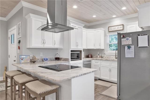 kitchen with island range hood, kitchen peninsula, white cabinetry, and appliances with stainless steel finishes