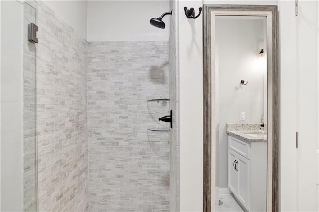 bathroom featuring vanity and tiled shower