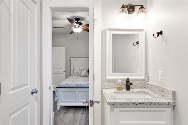 bathroom featuring ceiling fan, hardwood / wood-style floors, and vanity