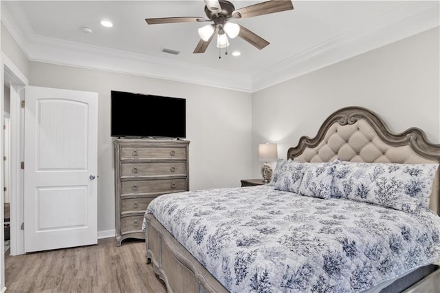 bedroom featuring ceiling fan, light wood-type flooring, and ornamental molding