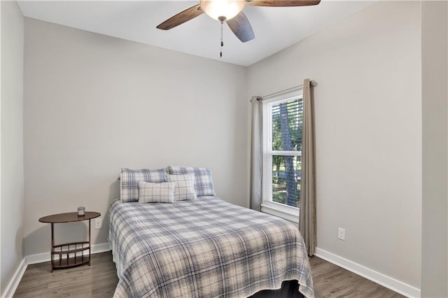 bedroom featuring ceiling fan and dark hardwood / wood-style floors