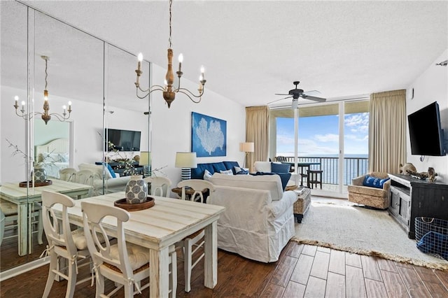 527 Beach Club Trl Unit D1103, Gulf Shores, AL 36542 - living area featuring a chandelier, floor to ceiling windows, a ceiling fan, dark wood-style flooring, and a textured ceiling