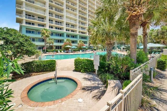 527 Beach Club Trl Unit D1103, Gulf Shores, AL 36542 - community pool featuring a hot tub and a patio area