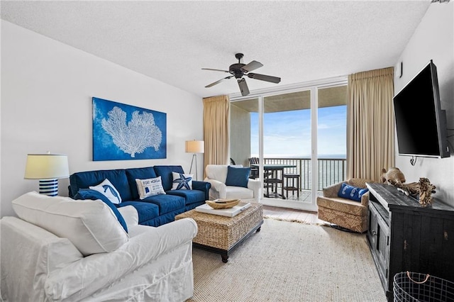 527 Beach Club Trl Unit D1103, Gulf Shores, AL 36542 - living area with expansive windows, ceiling fan, a textured ceiling, and wood finished floors