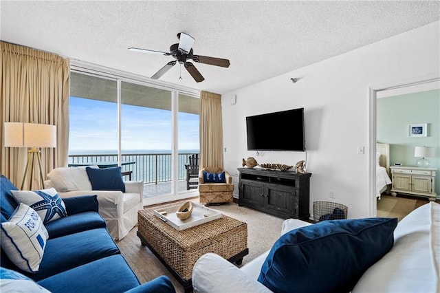 527 Beach Club Trl Unit D1103, Gulf Shores, AL 36542 - living area featuring a textured ceiling, expansive windows, and ceiling fan