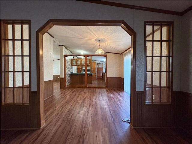 unfurnished living room featuring crown molding and hardwood / wood-style flooring