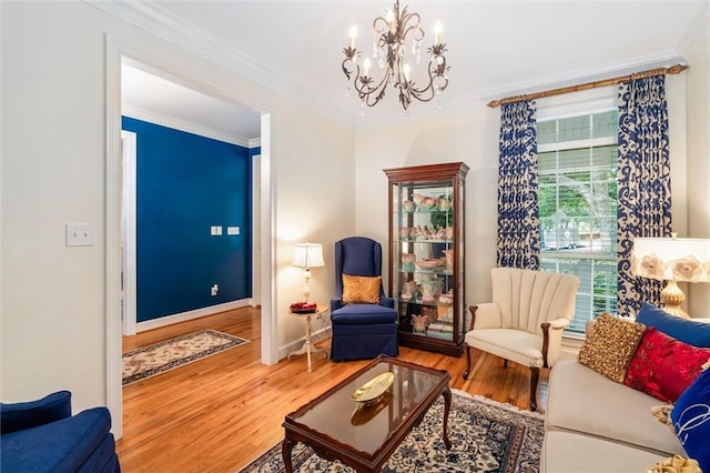 living room with a chandelier, hardwood / wood-style floors, and ornamental molding