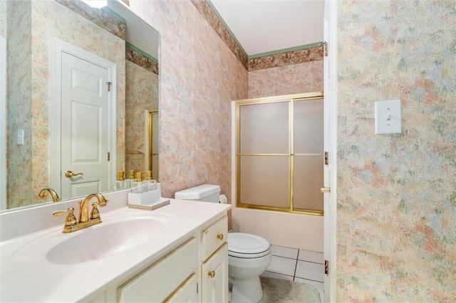 full bathroom with shower / bath combination with glass door, tile patterned flooring, vanity, and toilet