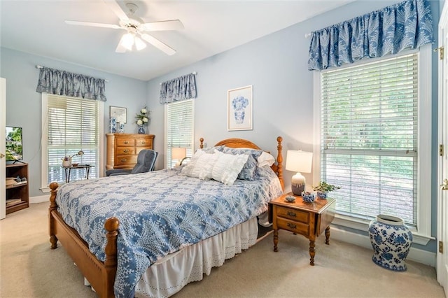 bedroom featuring ceiling fan and light carpet