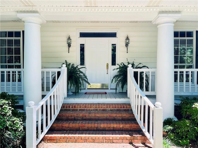 view of exterior entry with covered porch